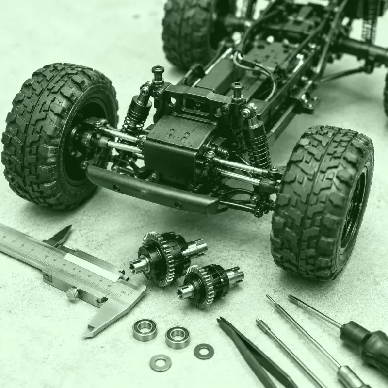 Chasis y piezas de un auto RC revisados con herramientas de precisión